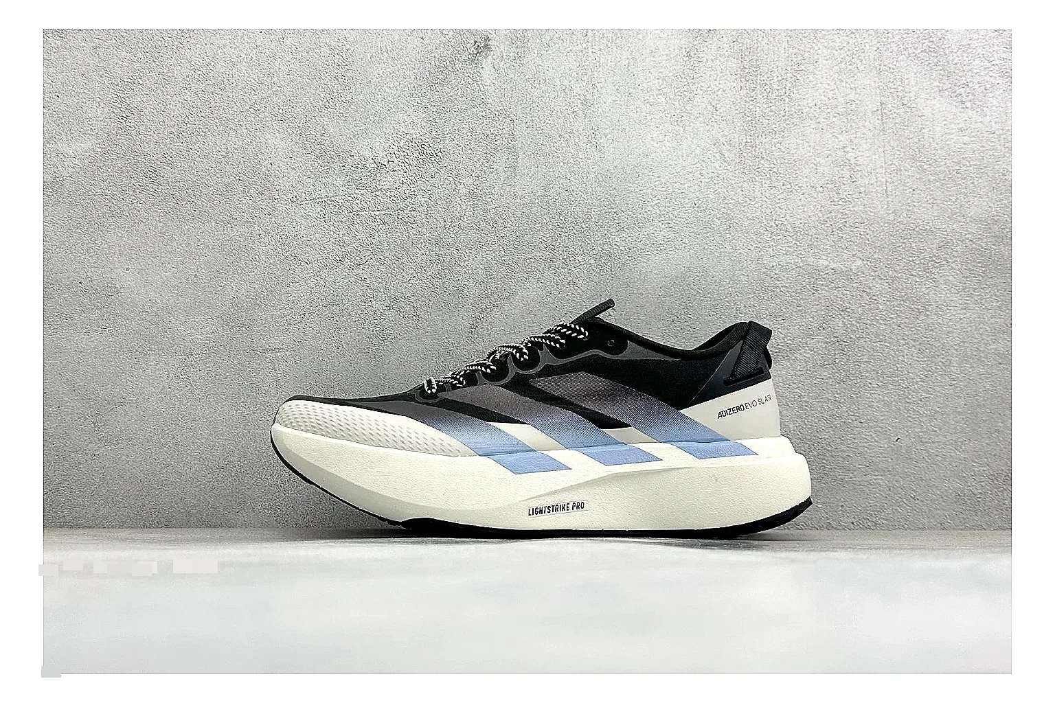 Adidas Adizero Evo Black spreadsheet record photo showing black racing upper, sculpted white sole, Adidas striping, and lightweight performance silhouette