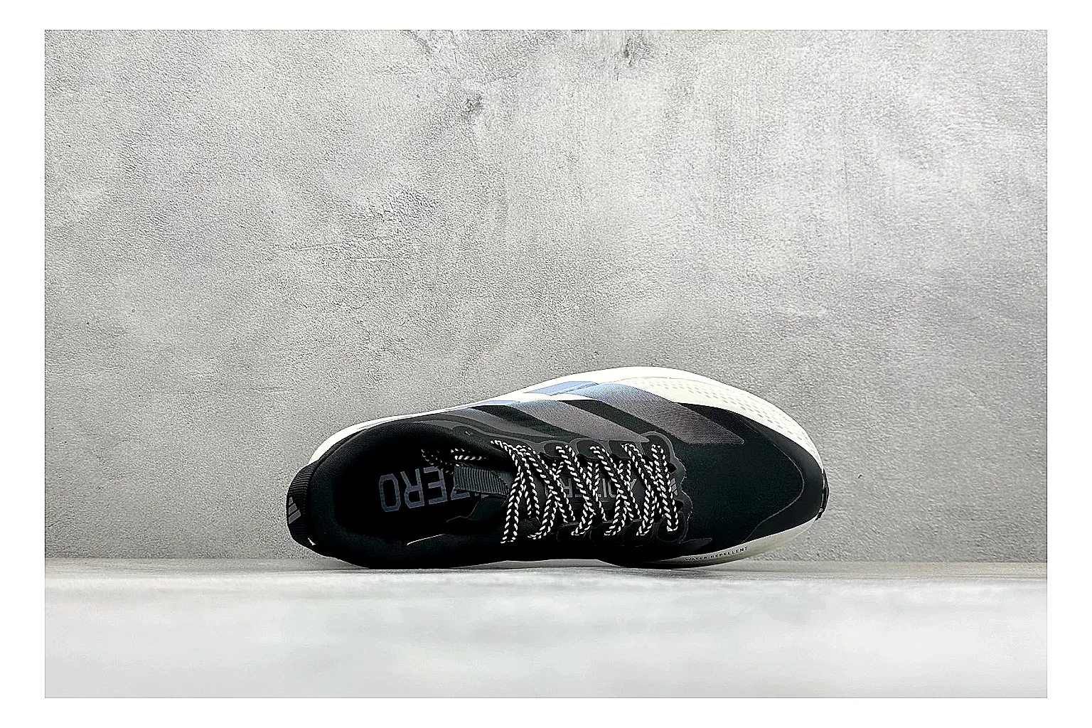 Adidas Adizero Evo Black spreadsheet record photo showing black racing upper, sculpted white sole, Adidas striping, and lightweight performance silhouette thumbnail 2