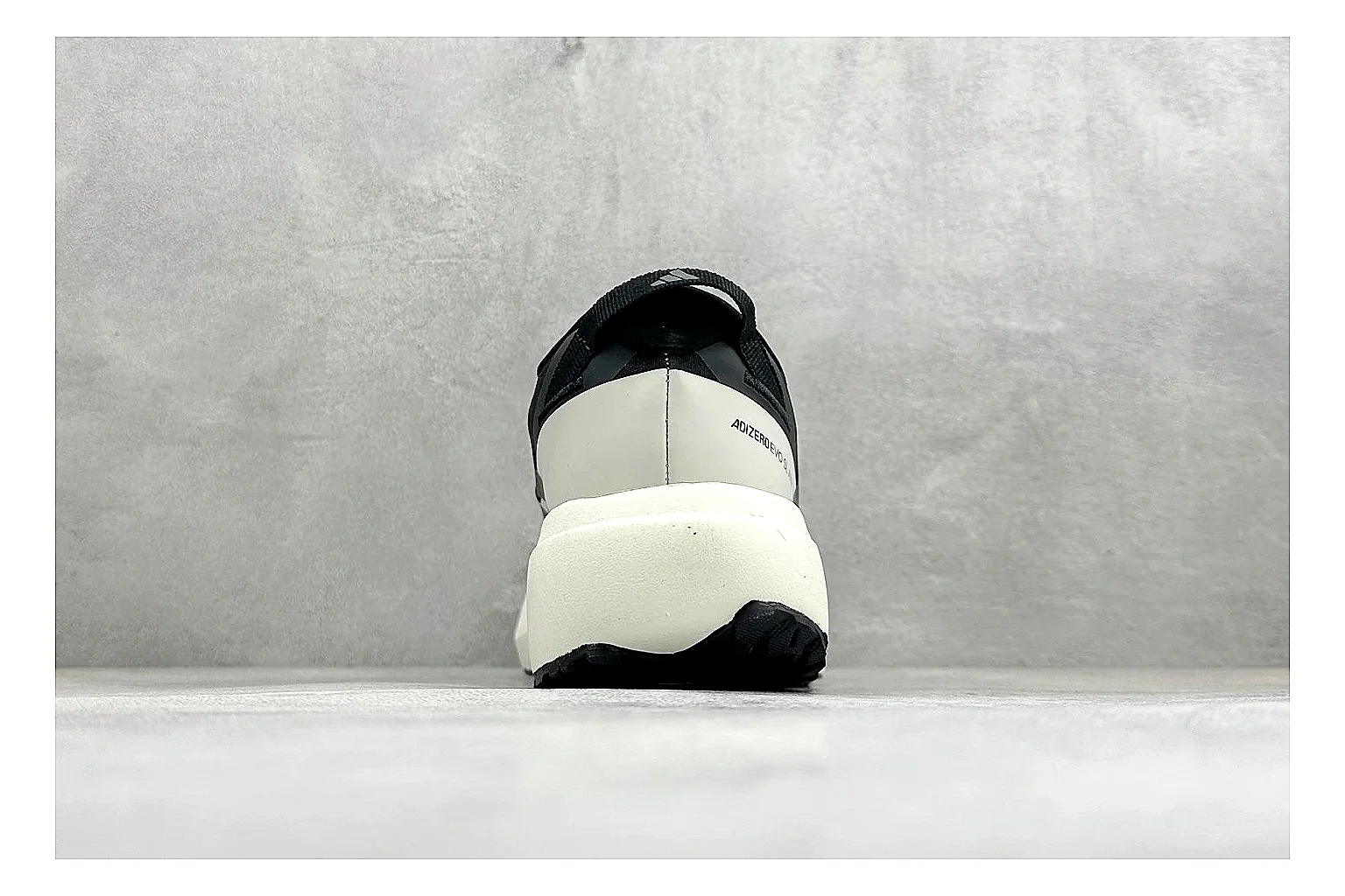 Adidas Adizero Evo Black spreadsheet record photo showing black racing upper, sculpted white sole, Adidas striping, and lightweight performance silhouette thumbnail 3