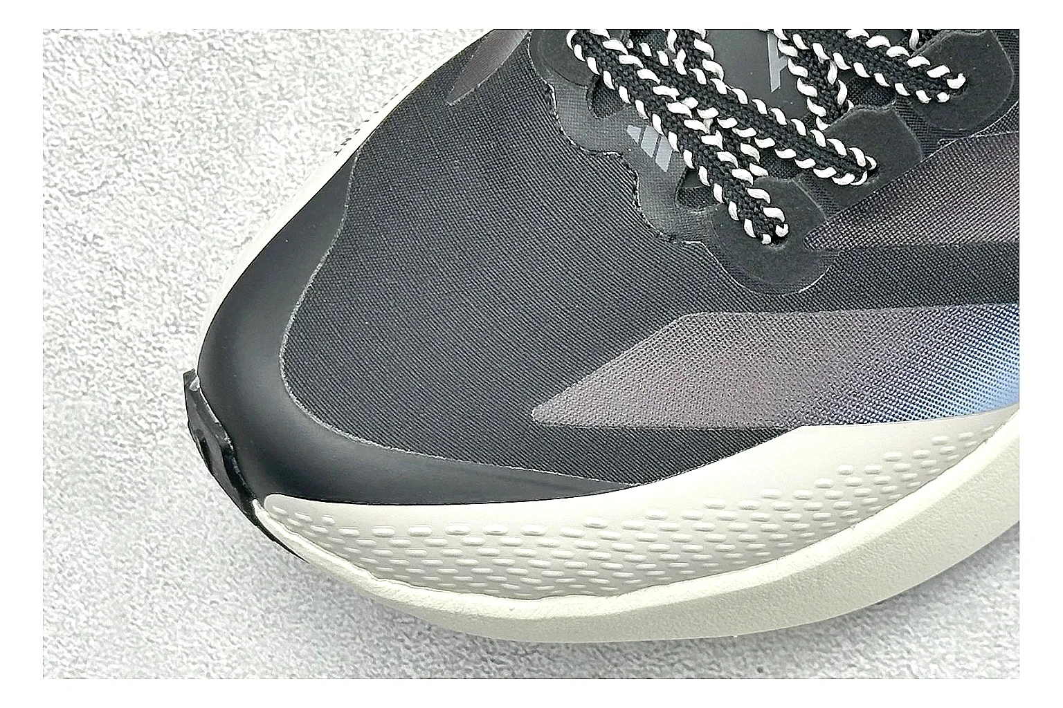 Adidas Adizero Evo Black spreadsheet record photo showing black racing upper, sculpted white sole, Adidas striping, and lightweight performance silhouette thumbnail 5