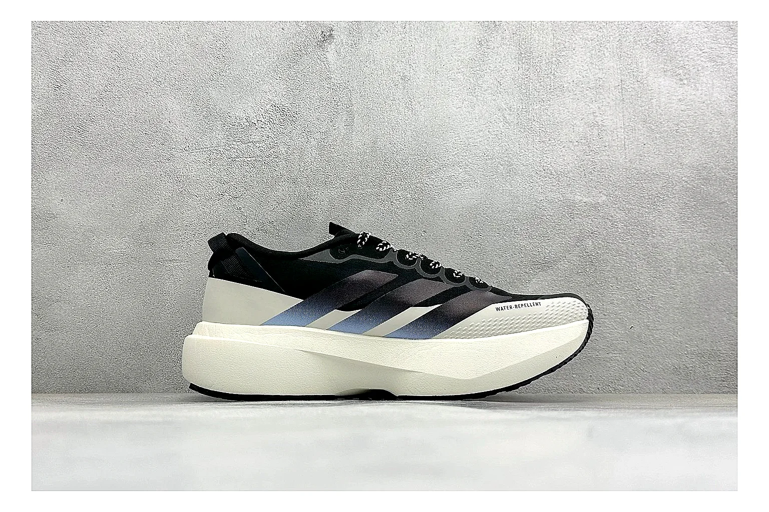 Adidas Adizero Evo Black spreadsheet record photo showing black racing upper, sculpted white sole, Adidas striping, and lightweight performance silhouette thumbnail 6