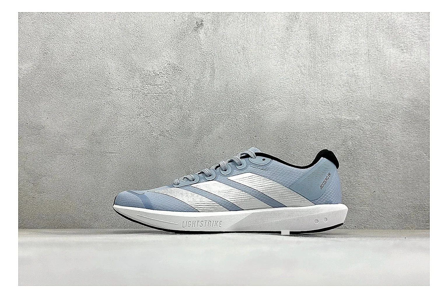 Adidas Adizero Grey Blue spreadsheet record photo showing grey lightweight runner upper, blue Adidas striping, slim racing shape, and low performance sole