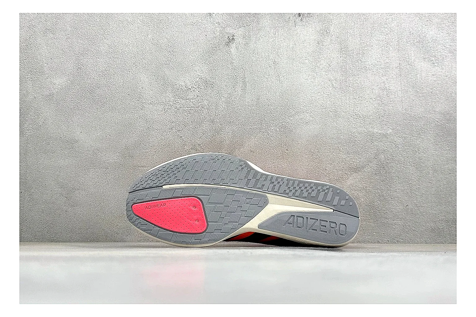Adidas Adizero Orange Black spreadsheet record photo showing orange runner upper, black three-stripe contrast, lightweight racing shape, and thin performance sole