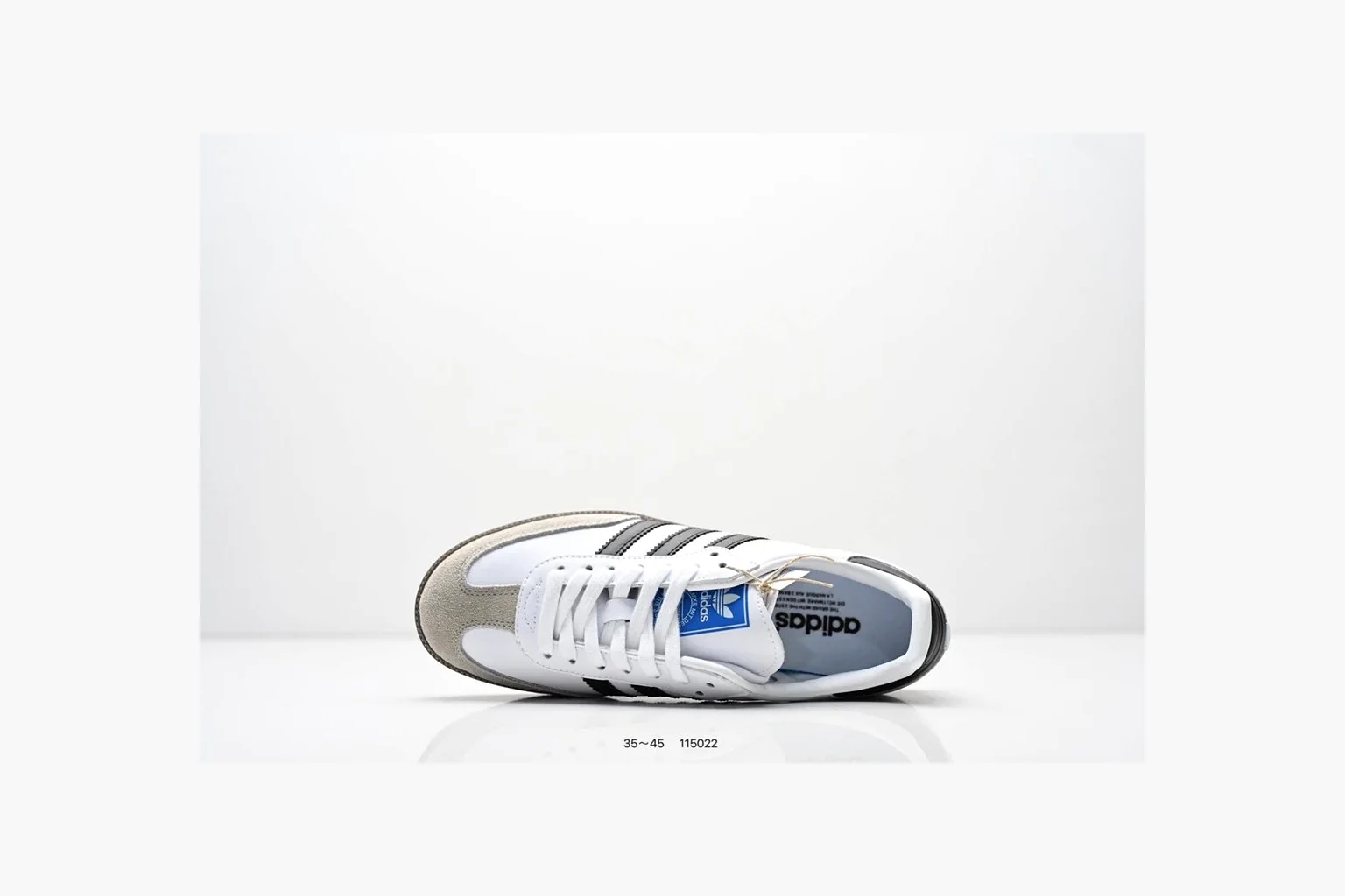 Adidas Samba OG White Black Blue spreadsheet record photo showing white leather-suede low-top upper, black three stripes, blue heel detail, gum terrace sole, and slim Samba profile thumbnail 2