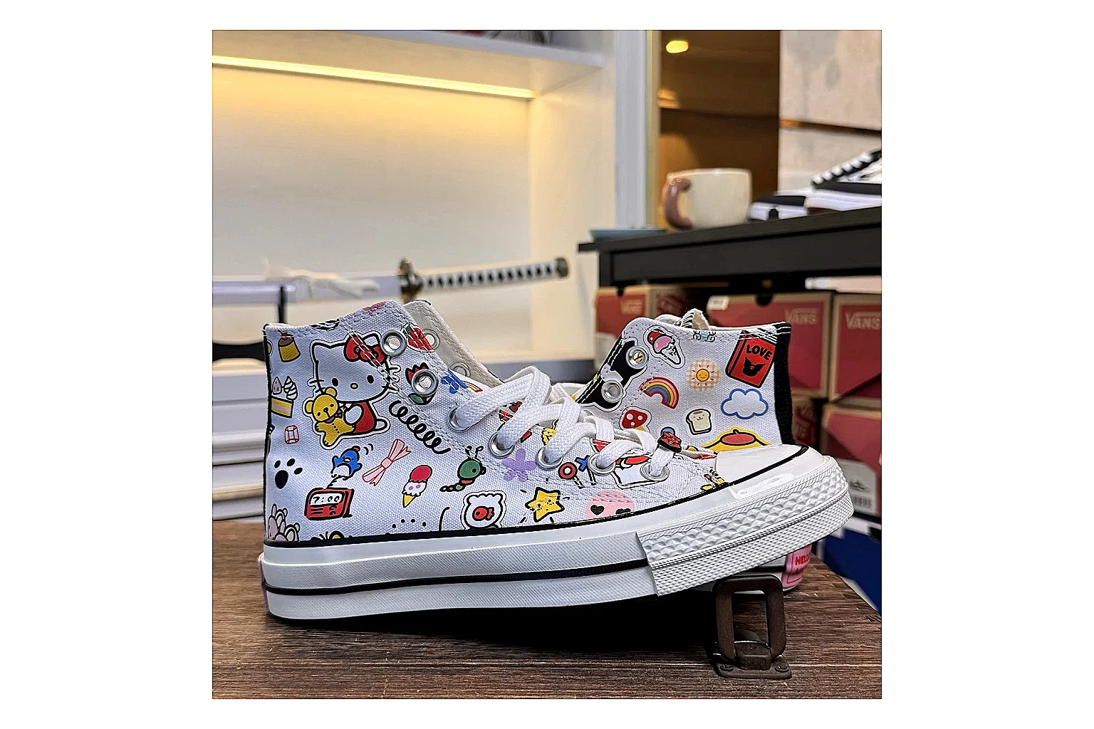Converse Hello Kitty Chuck 70 High Top spreadsheet record photo showing white canvas high-top upper, colorful character graphics, metal eyelets, rubber toe cap, and elevated vintage sole thumbnail 2