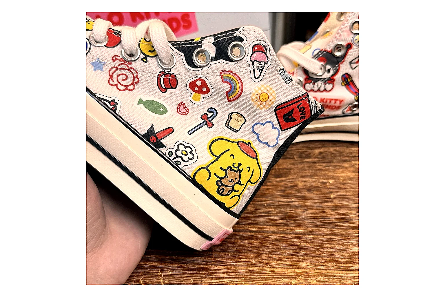 Converse Hello Kitty Chuck 70 High Top spreadsheet record photo showing white canvas high-top upper, colorful character graphics, metal eyelets, rubber toe cap, and elevated vintage sole thumbnail 5