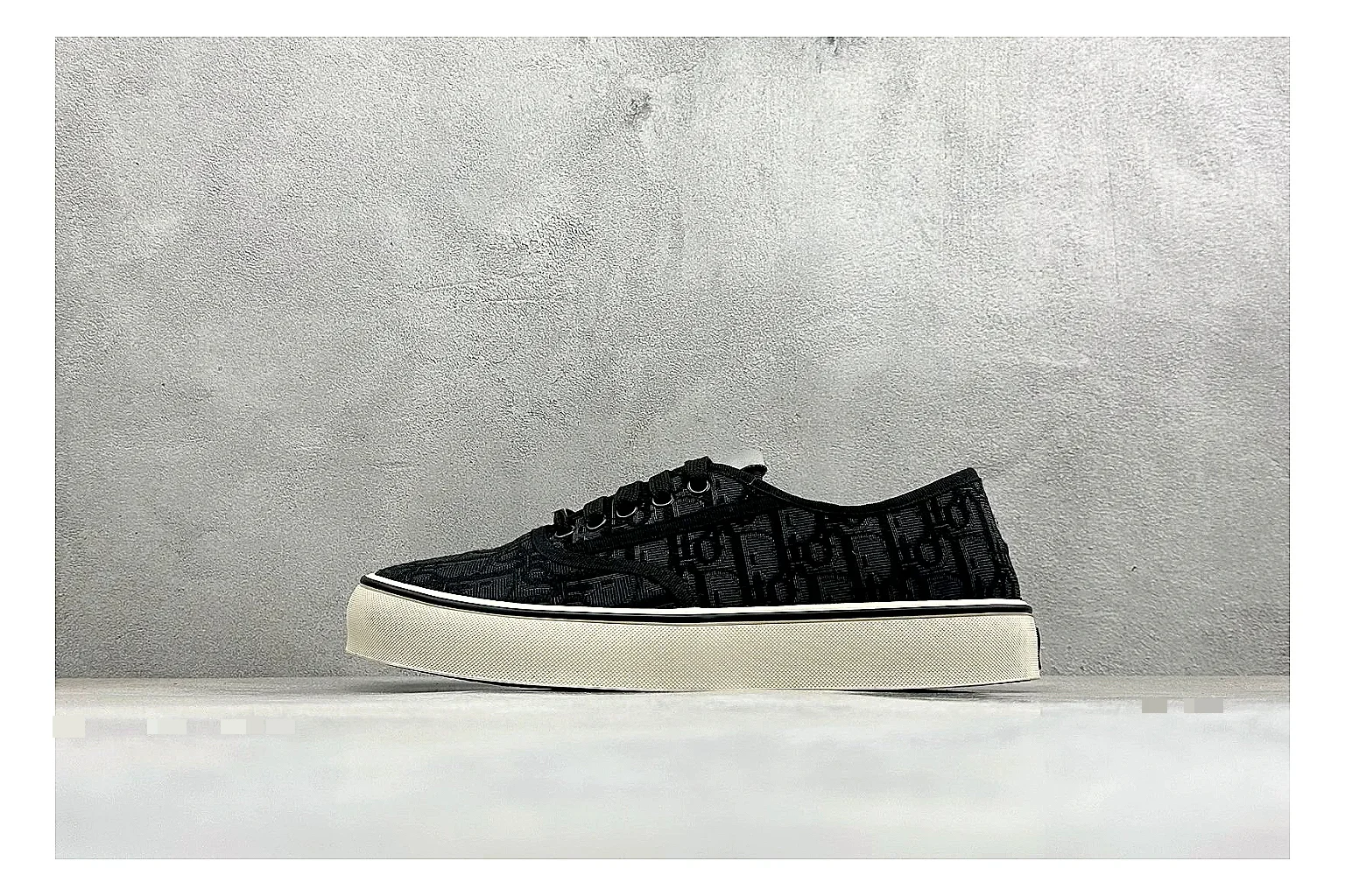 Dior Act Slide Black Low-Top spreadsheet record photo showing black monogram-style upper, low slip-on shape, chunky dark sole, and luxury casual profile