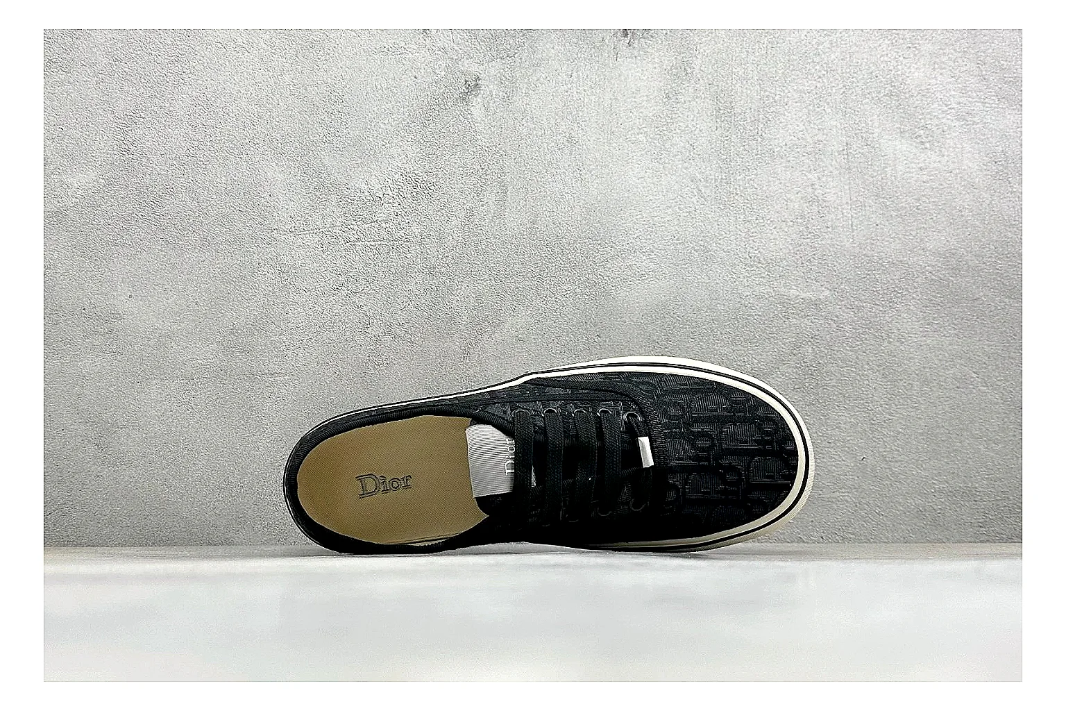 Dior Act Slide Black Low-Top spreadsheet record photo showing black monogram-style upper, low slip-on shape, chunky dark sole, and luxury casual profile thumbnail 2