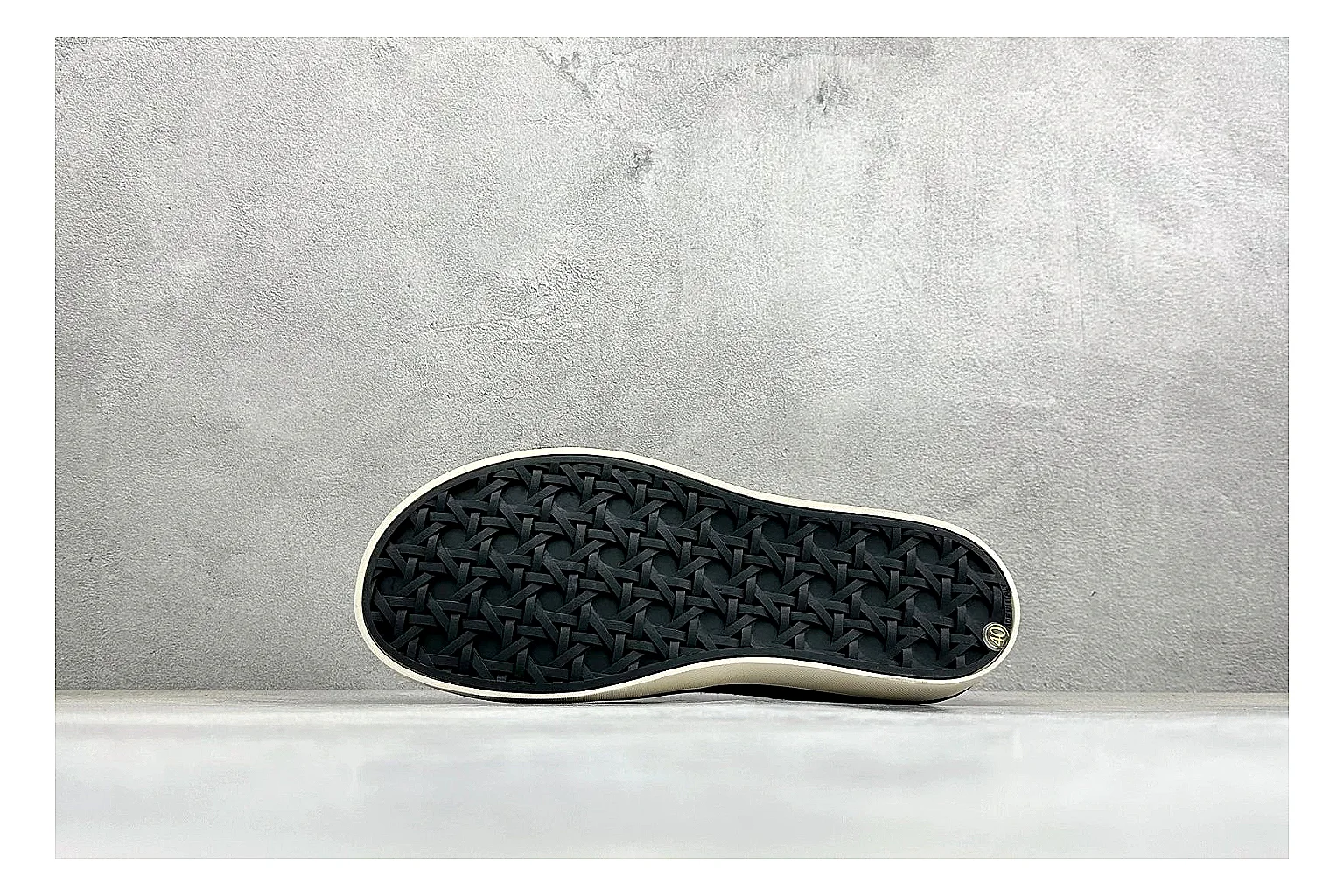Dior Act Slide Black Low-Top spreadsheet record photo showing black monogram-style upper, low slip-on shape, chunky dark sole, and luxury casual profile