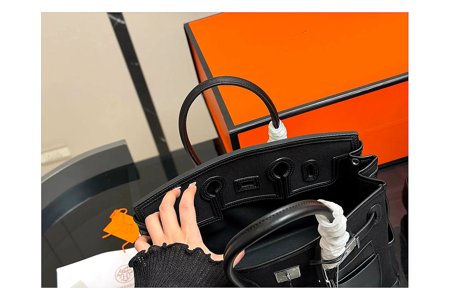 Hermes Birkin Style Black spreadsheet record photo showing black leather structured body, top handles, flap-and-strap shape, and polished hardware