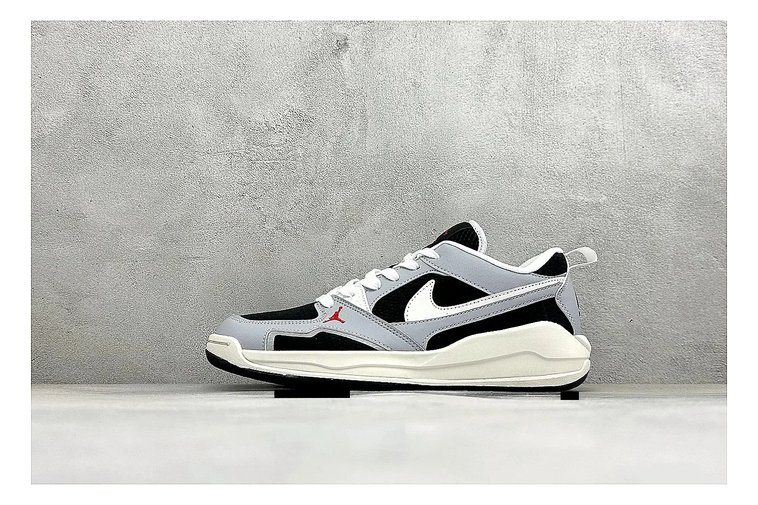 Jordan CMFT Black White spreadsheet record photo showing black and white layered panels, low padded collar, visible Jordan styling cues, and a compact court sole