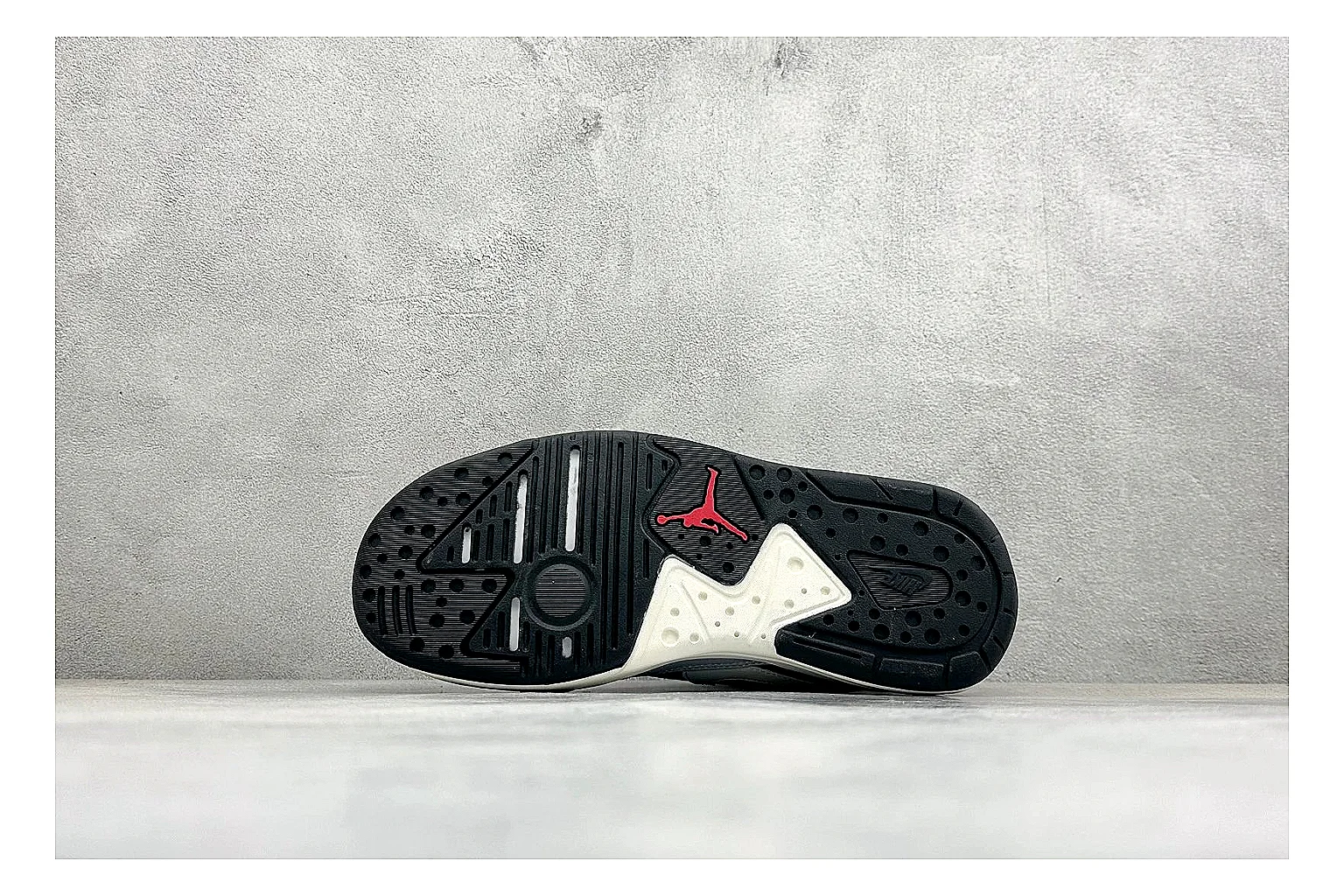 Jordan CMFT Black White spreadsheet record photo showing black and white layered panels, low padded collar, visible Jordan styling cues, and a compact court sole