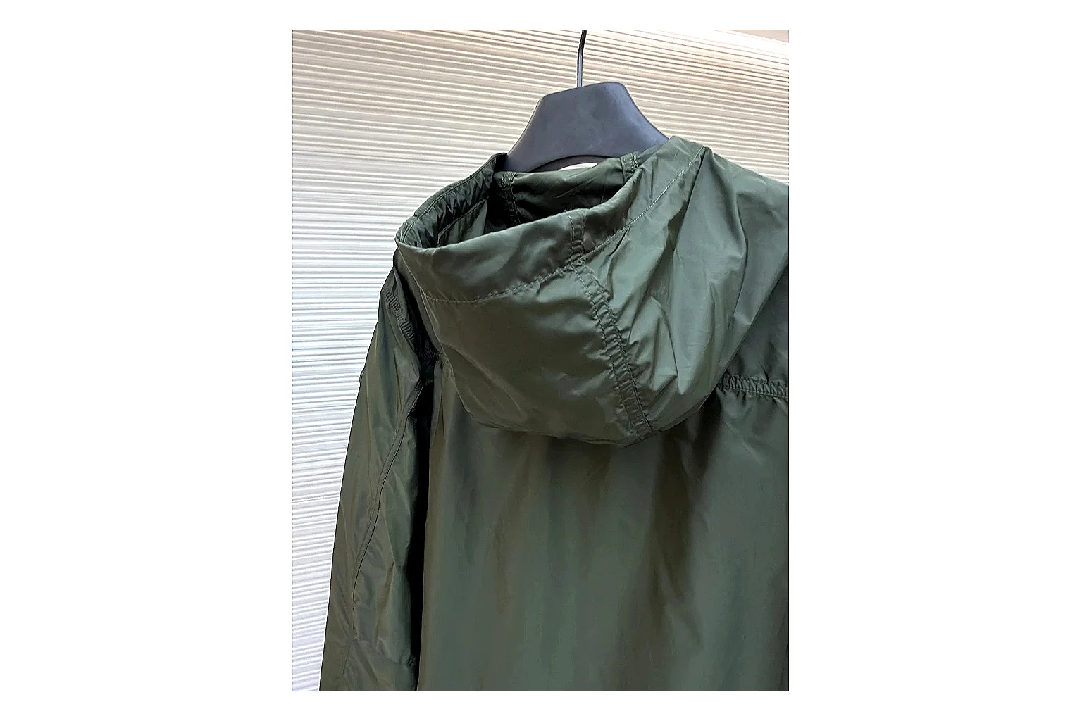 Moncler Nylon Hooded Jacket Olive Jacket spreadsheet record image with olive nylon hooded jacket with nylon texture, hood structure, zipper line, sleeve cuffs, and light shell shape