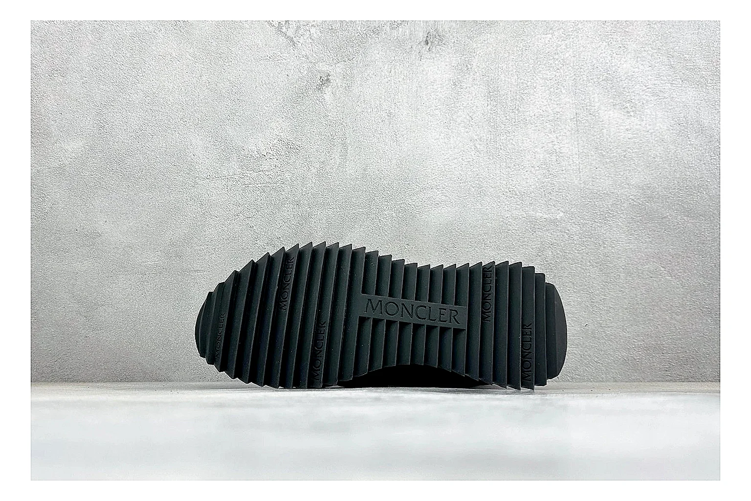 Moncler Pacey Black White spreadsheet record image showing black upper, white rugged outsole, low padded collar, and outdoor-leaning tread profile