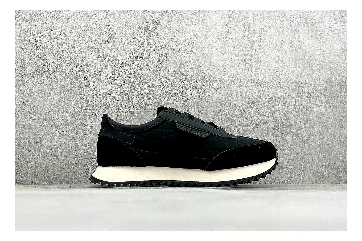 Moncler Pacey Black White spreadsheet record image showing black upper, white rugged outsole, low padded collar, and outdoor-leaning tread profile thumbnail 6