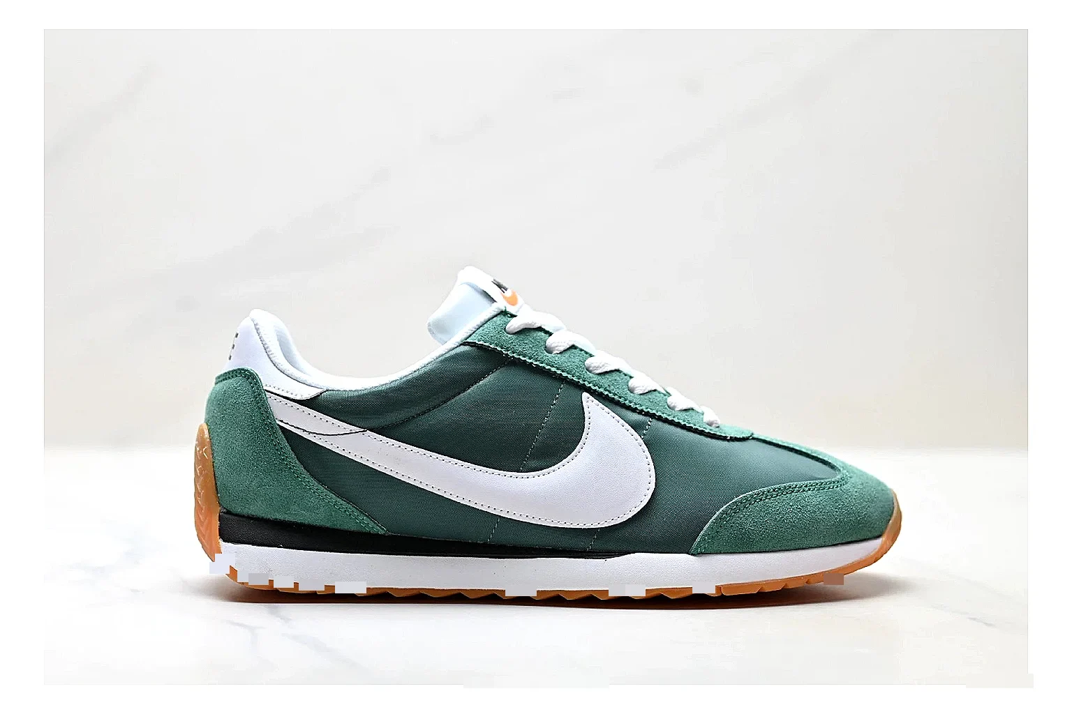 Nike Cortez Green White spreadsheet record photo showing green white leather low-top upper, slim retro runner profile, Swoosh detail, and classic Cortez sole