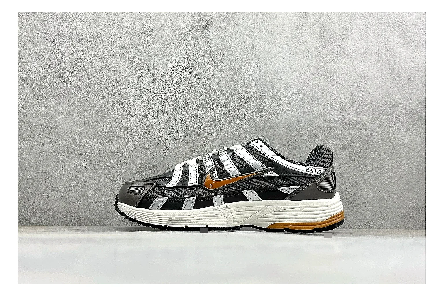 Nike P-6000 Black Orange spreadsheet record photo showing black layered runner upper, orange accent hits, retro P-6000 paneling, and cushioned casual sole