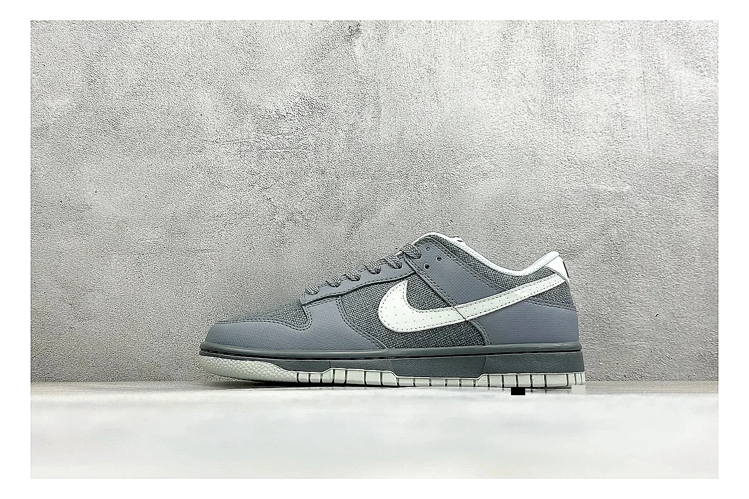 Nike SB Dunk Low Grey spreadsheet record photo showing grey low-top skate upper, white Swoosh, padded collar, and classic Dunk sole