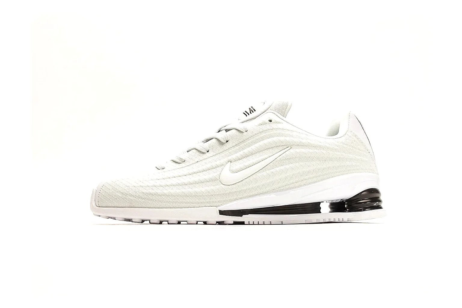 Nike Shox Z White Sneakers spreadsheet record photo showing white streamlined layered upper, small Swoosh, black heel cushioning columns, and modern low runner shape