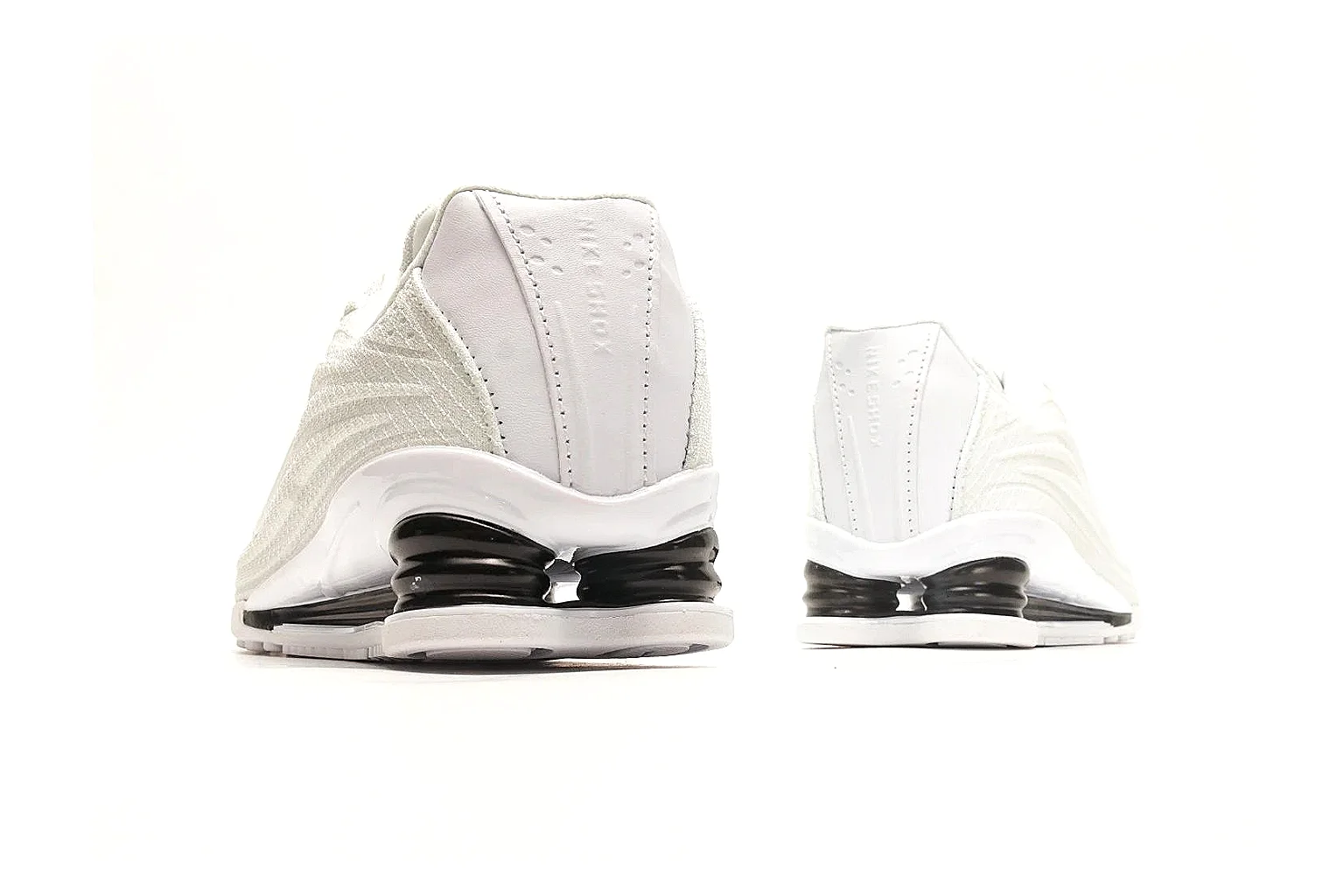 Nike Shox Z White Sneakers spreadsheet record photo showing white streamlined layered upper, small Swoosh, black heel cushioning columns, and modern low runner shape thumbnail 3