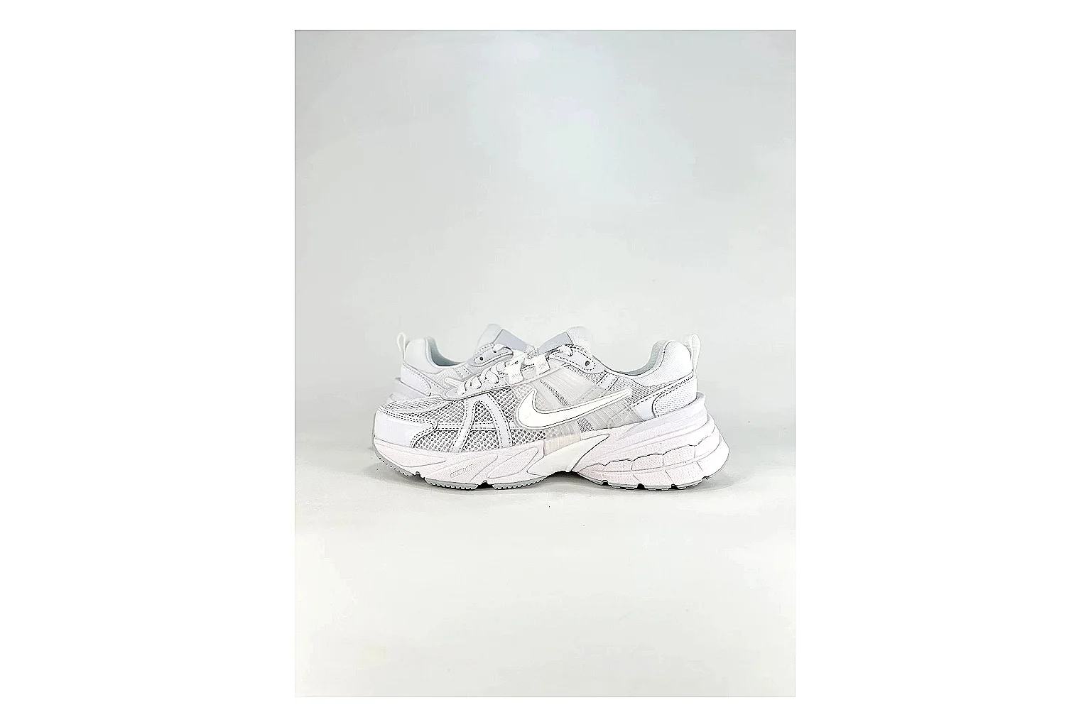 Nike V2K Run White Sneakers spreadsheet record image with white retro runner sneakers with mesh-leather texture, side-profile shape, upper panel lines, and outsole detail