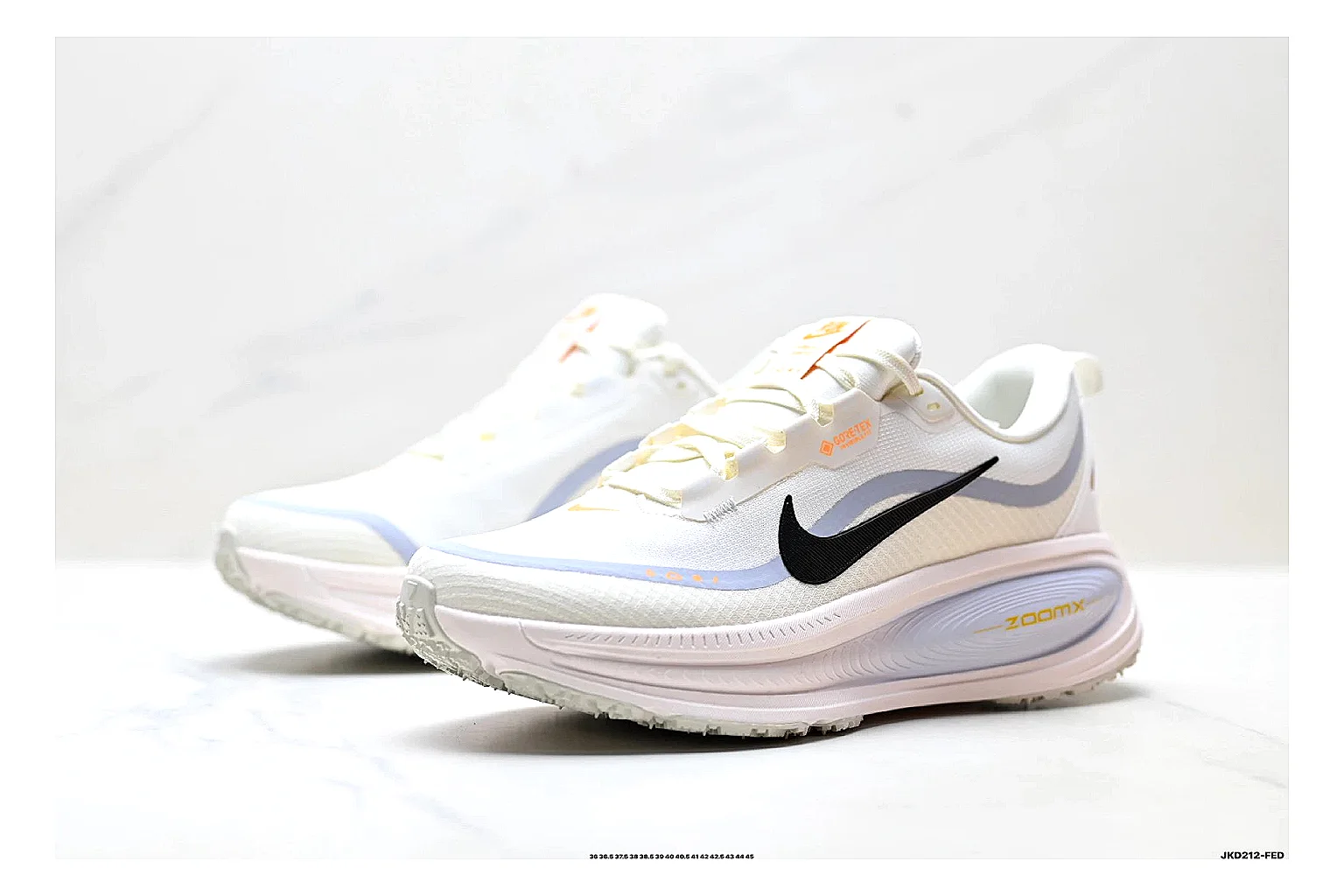 Nike Vomero White Orange spreadsheet record photo showing white mesh runner upper, orange accents, layered Vomero-style panels, and cushioned modern sole