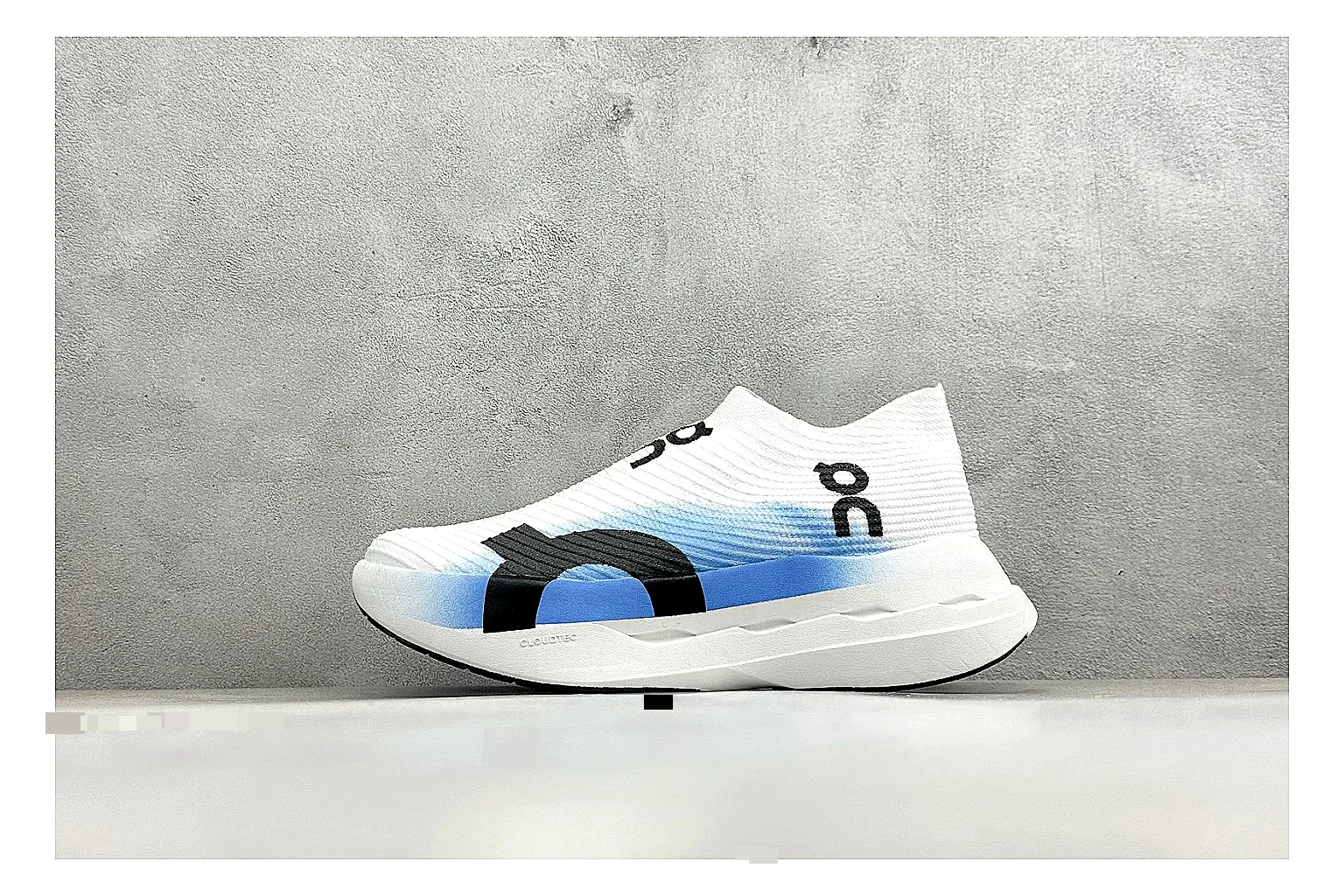 On Cloudboom White Blue spreadsheet record photo showing white performance mesh, blue gradient accents, slim racing profile, and segmented CloudTec sole