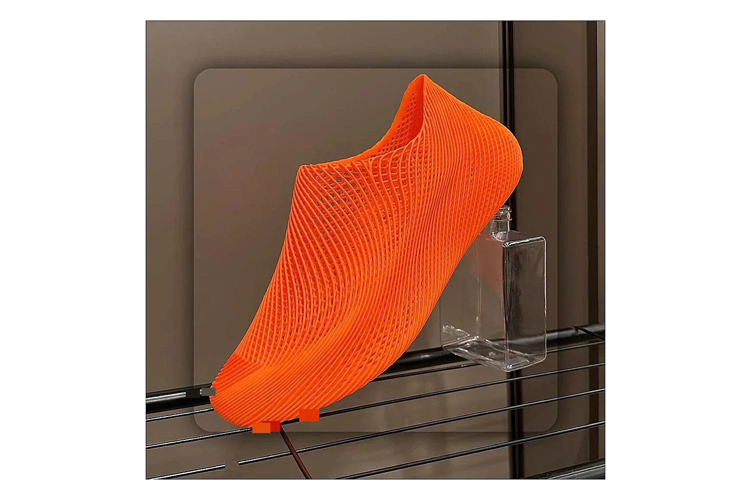 Other 4D Printed Orange Slip-On Sneakers spreadsheet record photo showing orange open-grid upper, seamless slip-on shape, sculpted sole, and futuristic lightweight profile