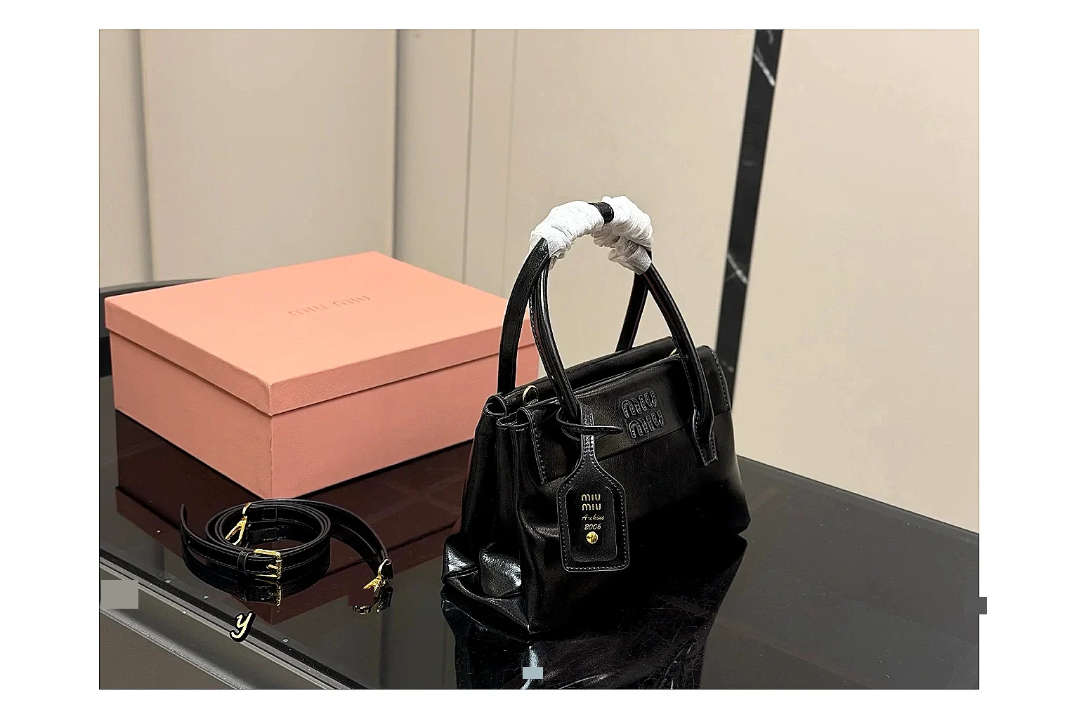 Prada Mini Top Handle Black spreadsheet record photo showing black leather mini bag body, structured top handle, compact luxury shape, and clean hardware details