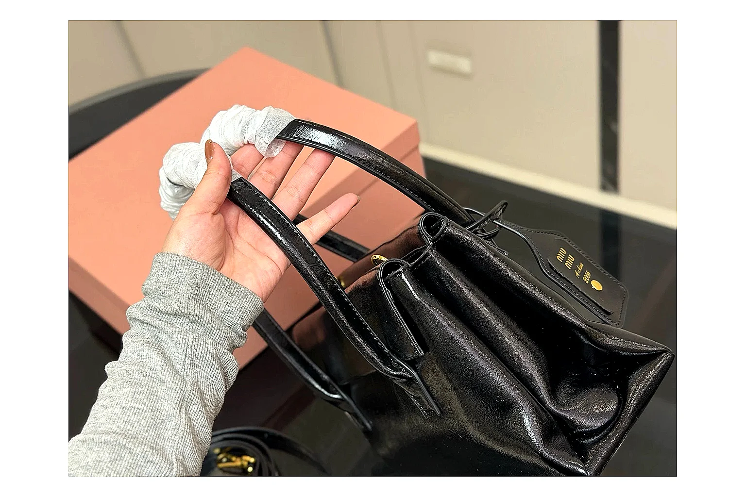 Prada Mini Top Handle Black spreadsheet record photo showing black leather mini bag body, structured top handle, compact luxury shape, and clean hardware details thumbnail 5