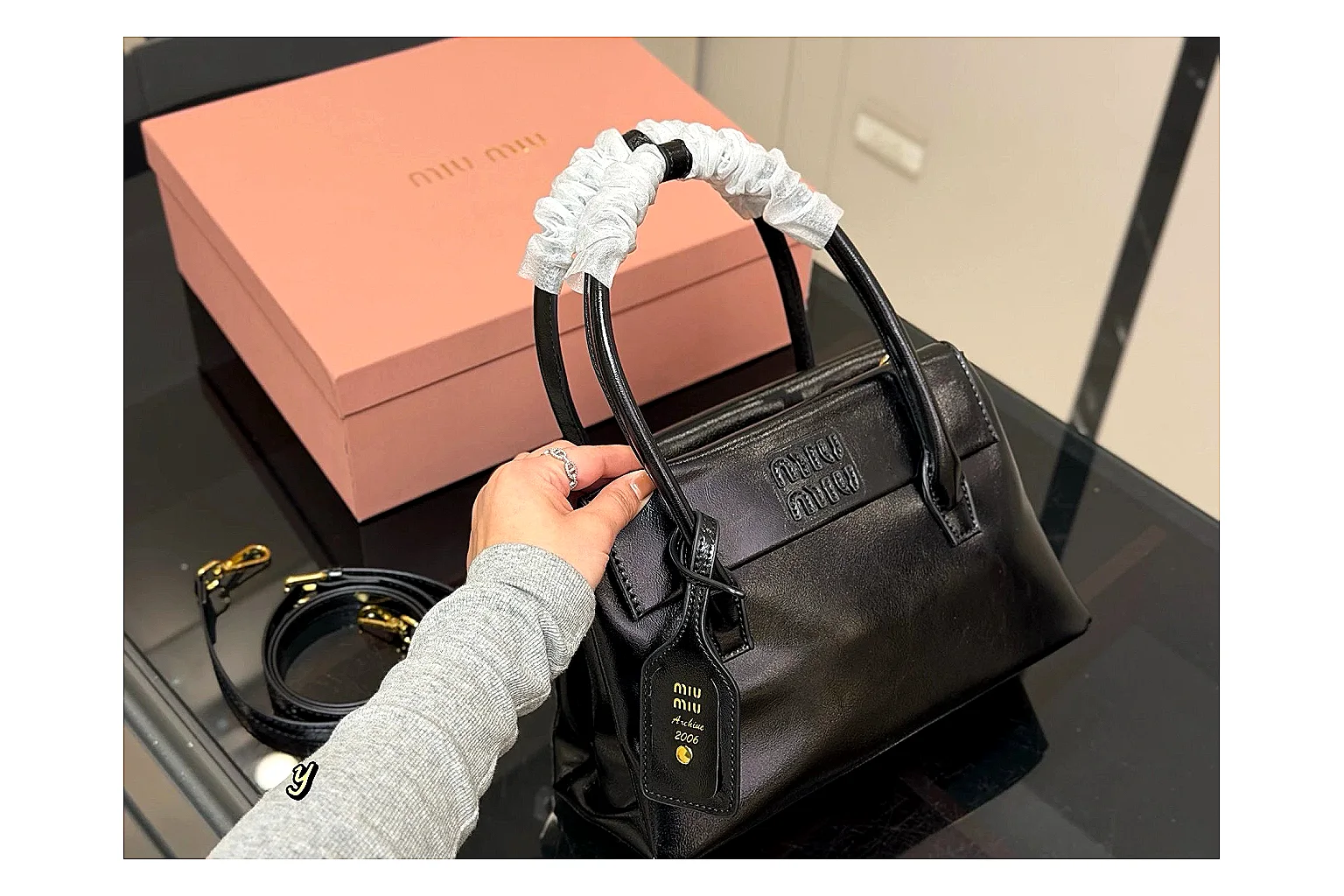 Prada Mini Top Handle Black spreadsheet record photo showing black leather mini bag body, structured top handle, compact luxury shape, and clean hardware details thumbnail 6