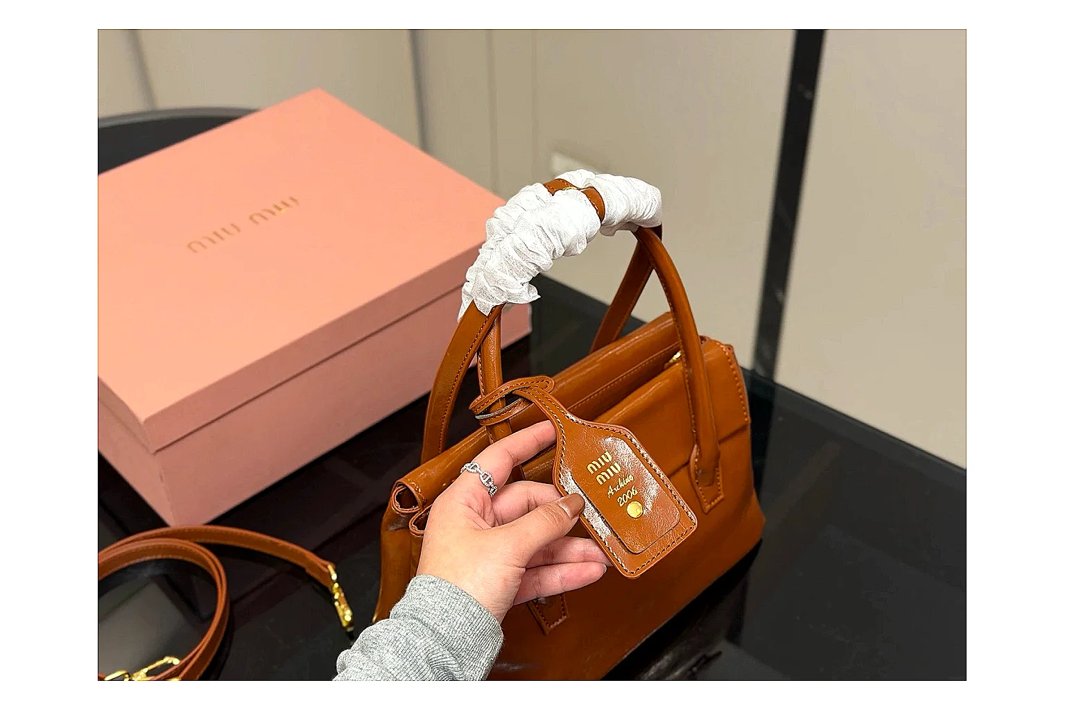 Prada Mini Top Handle Orange Brown spreadsheet record photo showing orange brown leather mini bag body, structured top handle, compact shape, and clean hardware details thumbnail 2
