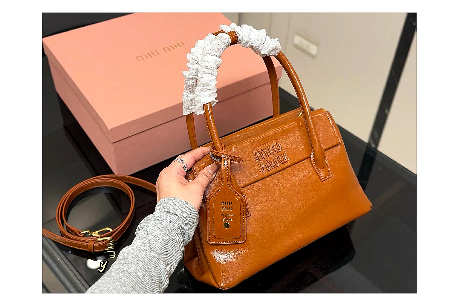 Prada Mini Top Handle Orange Brown spreadsheet record photo showing orange brown leather mini bag body, structured top handle, compact shape, and clean hardware details thumbnail 6